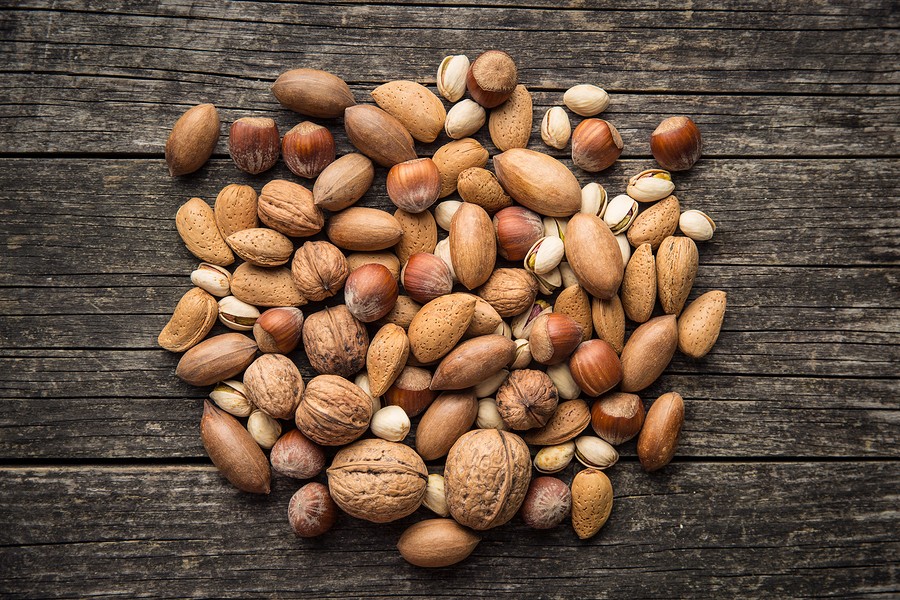 Different types of nuts in the nutshell. Hazelnuts, walnuts, almonds, pecan nuts and pistachio nuts 